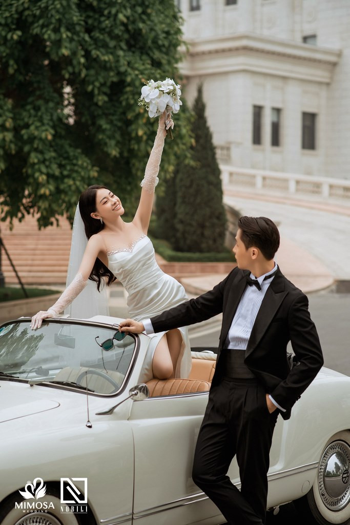 Cặp đôi nắm tay nhau đi giữa cánh đồng lúa xanh mướt, tượng trưng cho sự bình yên và gắn kết